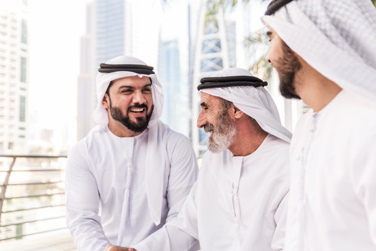 Businessmen in Dubai speaking about business. Local people with traditional clothes