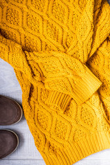 Set of women's autumn, winter clothes - yellow pullover oversize, suede brown boots. Fashionable clothes for walks, flat lay