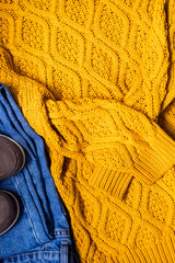 Set of women's autumn, winter clothes - jeans, yellow pullover oversize, suede brown boots. Fashionable clothes for walks, flat lay