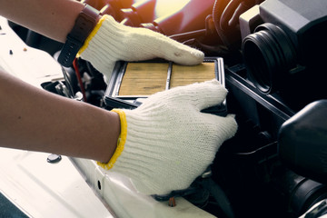 Obraz premium Hand of man wear white gloves maintenance used raise the air filter panel.