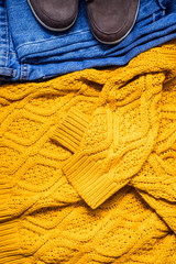 Set of women's autumn, winter clothes - jeans, yellow pullover oversize, suede brown boots. Fashionable clothes for walks, flat lay