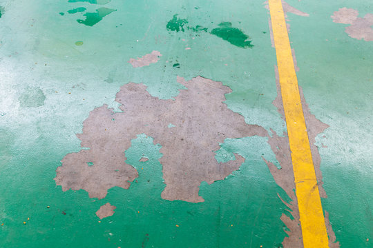 Peeling Damaged Epoxy Layered Flooring Of Workshop In Garage