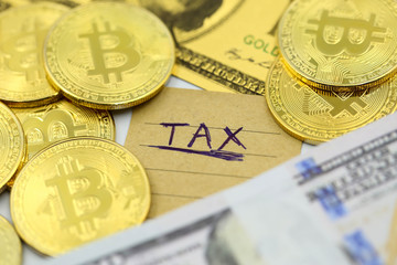 Bitcoin Crypto Currency with TAX message and dollars money ,Determining the tax law of digital money Concept .