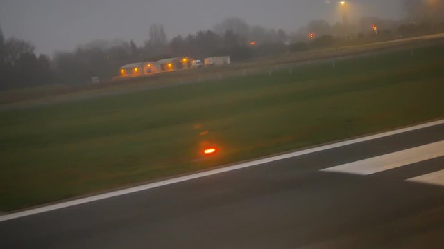 The plane takes off at the Brussels South Charleroi Airport in the early dark morning. From the ground to the cloudy sky.