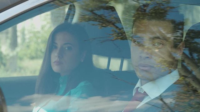 Arrogant multiethnic businesspeople in formalwear looking out from car window, expressing disdainful attitude, haughty, social superiors and dislikes people or activities regarded as lower-class.