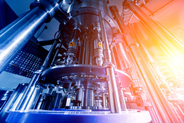 Automatic filling machine pours water into plastic PET bottles. Brewing production.