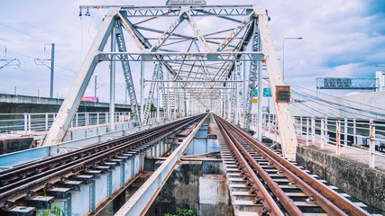 Fototapeta na wymiar Train trestle bridge over river . the railway bridge of iron.