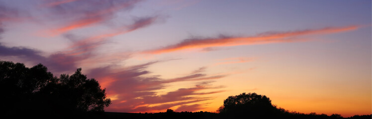 Tragic dark red clouds at sunset. Panorama