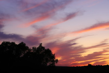 Tragic dark red clouds at sunset.