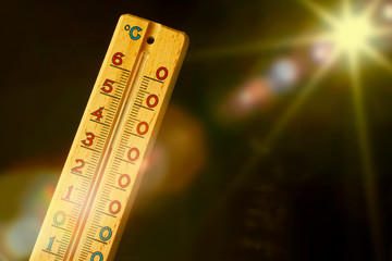 global warming - thermometer close up on black background