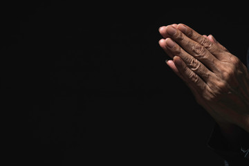 Hand of man while praying for religion. Concept peace and life.