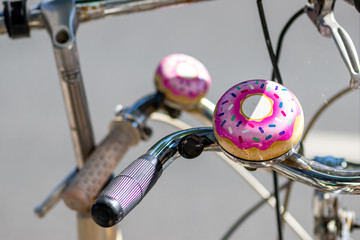 Lustige Fahrradklingel in pinkfarbener Donut-Optik mit Streuseln macht das gesunde Fahrrad fahren...