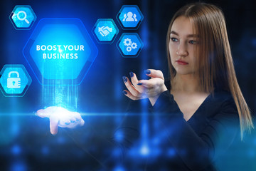 The concept of business, technology, the Internet and the network. A young entrepreneur working on a virtual screen of the future and sees the inscription: Boost your business