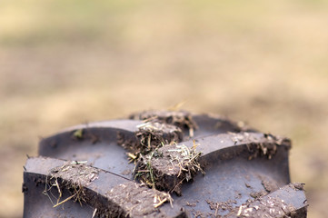 dirty tread wheel of agricultural machinery closeup, pattern, background