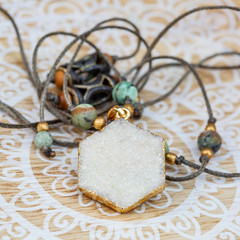 Hexagon druzy pendant mineral stone necklace on decorative background