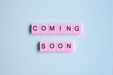 Coming soon word wooden cubes on a white background