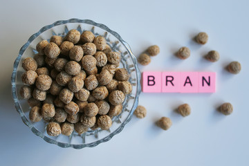 Bran, in a plate, on a white background, top view