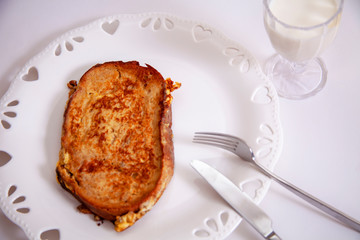 egg toast on white porcelain plate with heart (fried in hot oil)