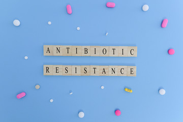 Concept showing of Antibiotic resistance with medicines or pills in wooden block letters.