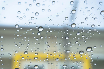 Blue Drops water drops on glass surface as background.
