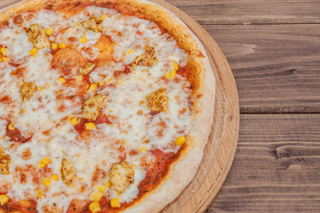 Hawaiian pizza on dark rustic wooden background. Top view, copy space