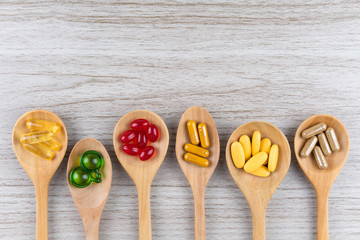 Natural supplements, vitamin or organic medicine, oil capsule, pill herbal from herbs good for health, herbs leaf in mortar isolated on white background, medicine and drug concept