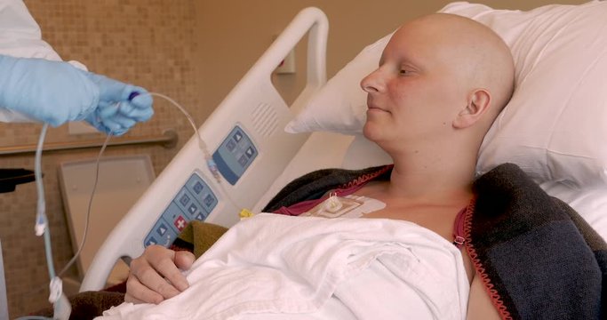 Nurse connecting an infusion connector to a CVC for chemotherapy