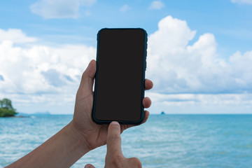 Close up hands of young man raise up his mobile phone, Copy space.