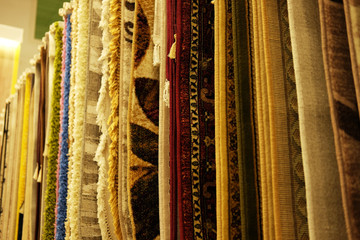 Assortment of different carpets in store.