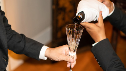 A man pouring champagne into a glass for a special event