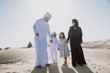 Arabian family spending a weekend in the desert, in Dubai