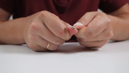 Man makes manicure at home. Concept of male beauty. Manicure on male hands. Nail file in male hands