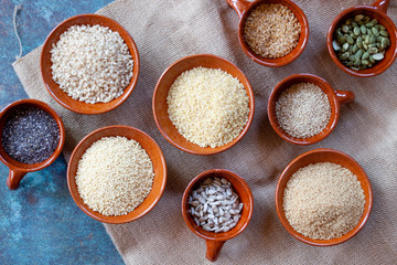Grains and seeds in ceramics bowls. Natural food