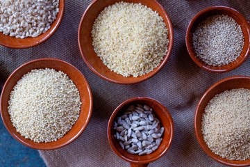 Grains and seeds in ceramic bowls