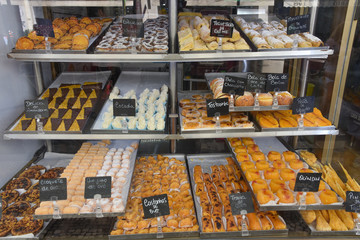 Lisbon, Portugal - July 27, 2019: Pasteis de Nata and traditional pastries on sale in a Lisbon bakery