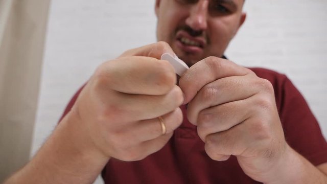 Man makes manicure at home. Concept of male beauty. Manicure on male hands. Nail file in male hands