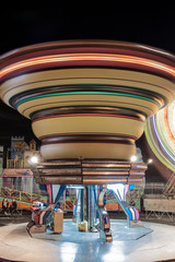 soft-focus of a carousel on moving, with a lot of little lights and colours during the night