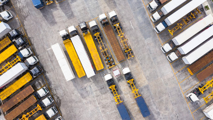 Aerial Top View of White Semi Truck with Cargo Trailer Parking lot.