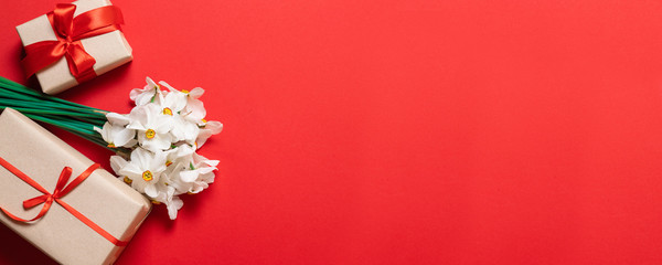 Happy Mothers Day text and beautiful red tulips with gift box on red background.