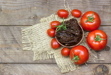 fresh and dried tomatoes on wooden background