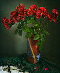 Still life with a bouquet of flowers. Red roses. Vintage.
