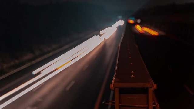 Time lapse of the A4 Highway in Germany Chemnitz. Long exposure of traffic on the move with close up of metal that seperates left and right with copy space