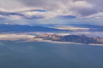 Fototapeta na wymiar Great Salt Lake Utah Aerial view from airplane looking toward Oquirrh Mountains and Antelope Island, Tooele, Magna, with sweeping cloudscape. United States.