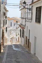 Fototapeta na wymiar White alley downhill in Casares, Andalusia, Spain