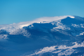winter landscape. mountains on horizon  covered with snow