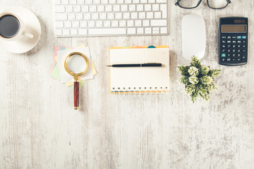 notepad with magnifier and computer with magnifier on desk