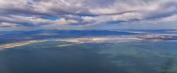 Fototapeta na wymiar Great Salt Lake Utah Aerial view from airplane looking toward Oquirrh Mountains and Antelope Island, Tooele, Magna, with sweeping cloudscape. United States.