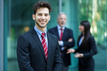 Business team smiling outdoor in a modern urban setting