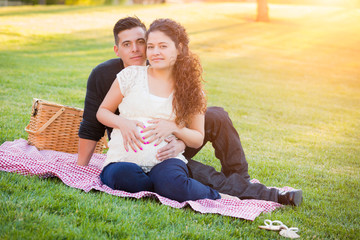Hispanic Pregnant Young Couple Portrait Outdoors