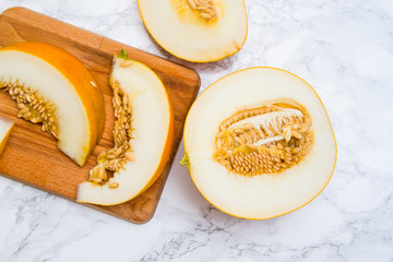 Ripe fresh cut melon on white background